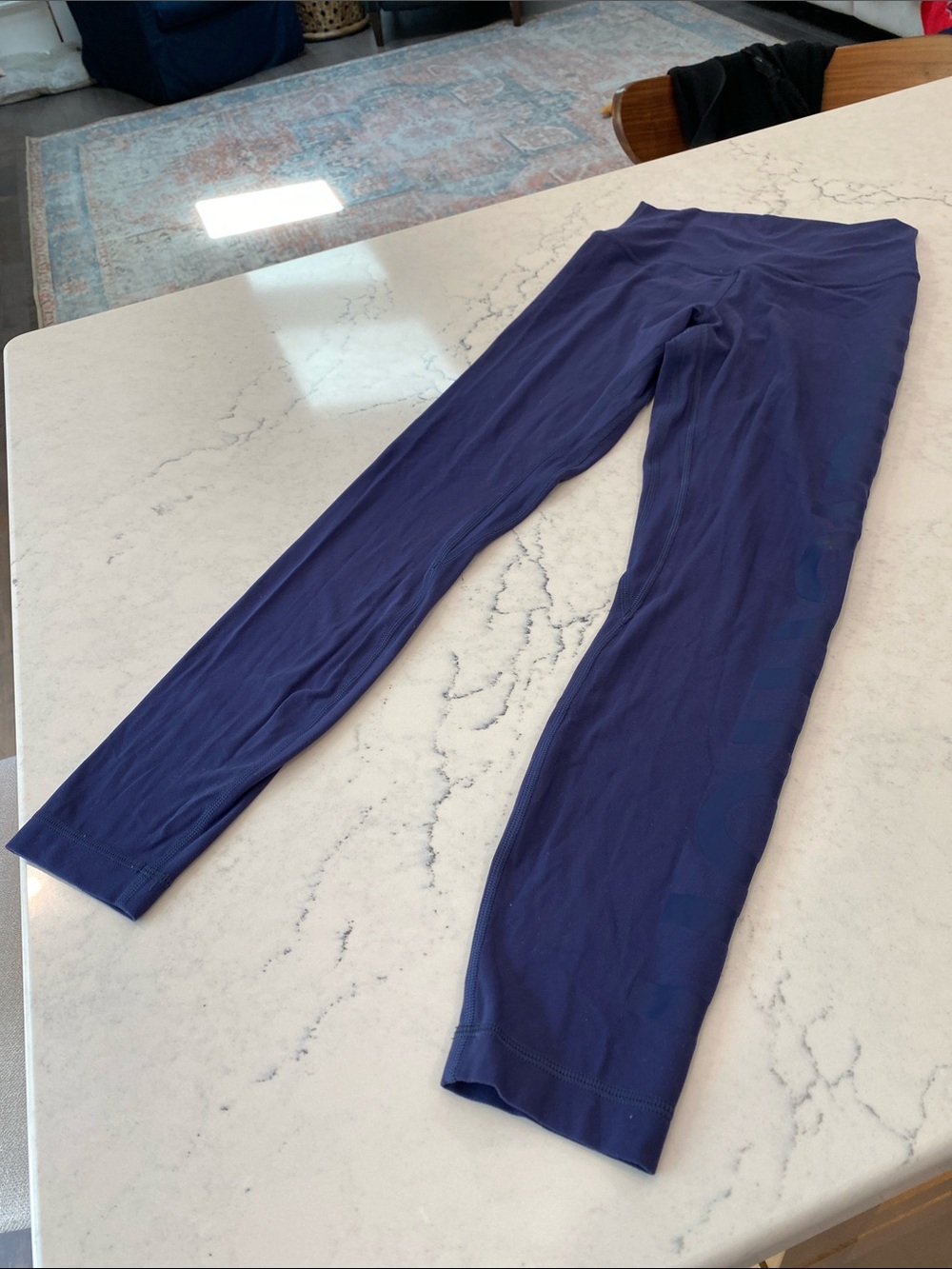 Navy Blue Lululemon leggings - size 4, with Logo down leg